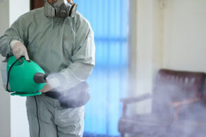 Worker spraying disinfectant spray